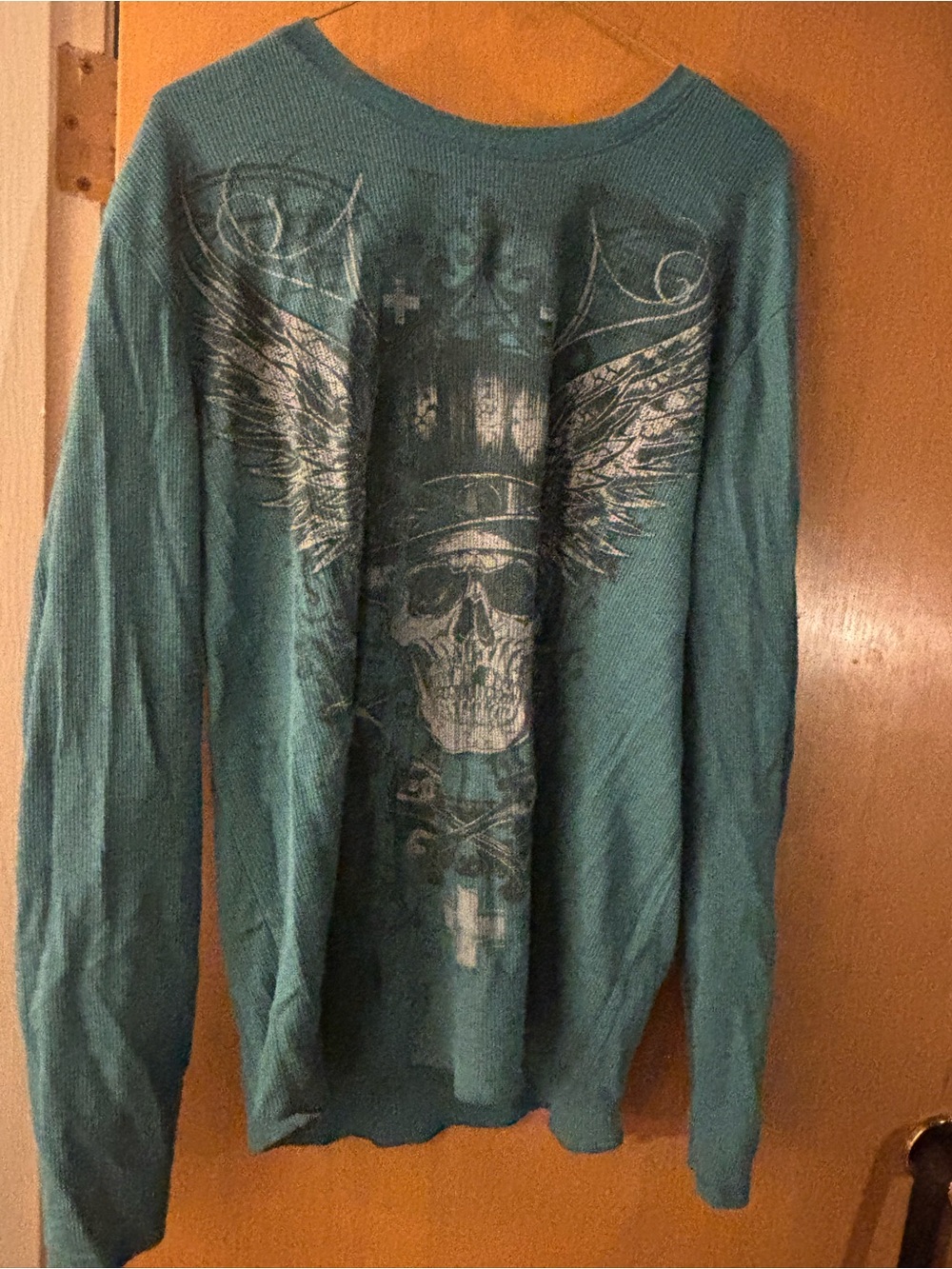 Womens Teal Graphic Long-Sleeve Shirt with Skull Wing Design